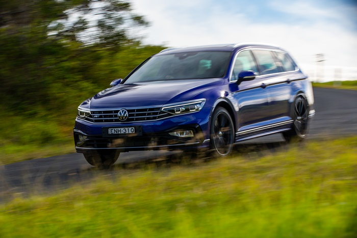 Blue 2021 Volkswagen Passat R-Line Varian driving on road