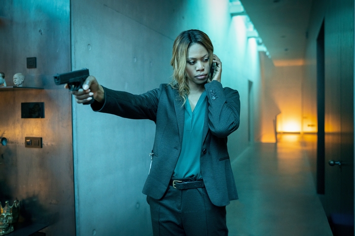 Laverne Cox in Jolt holding a gun