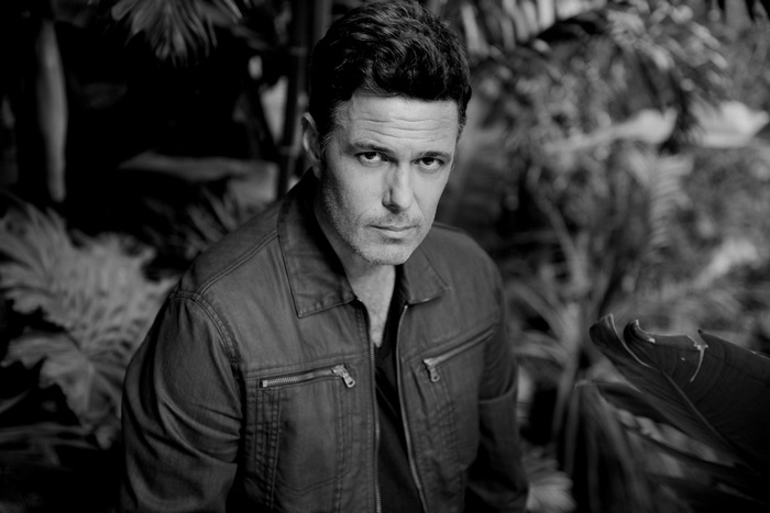 Carlos Bernard in a jacket, black and white portrait