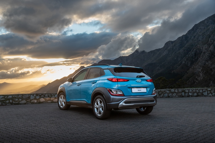 Blue 2021 Hyundai Kona SUV parked with mountains