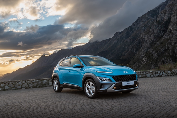 Blue 2021 Hyundai Kona SUV parked with mountains