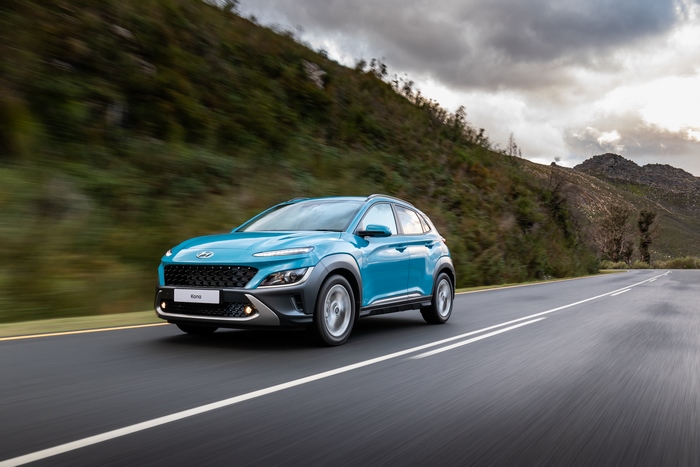 Blue 2021 Hyundai Kona SUV driving on a scenic road