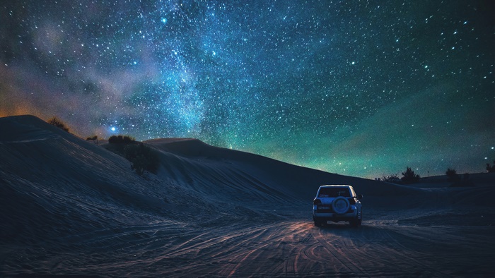 Starry Night Sky Over Desert Landscape