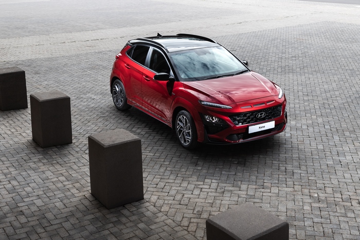 Red 2021 Hyundai Kona N Line SUV parked on brick pavement
