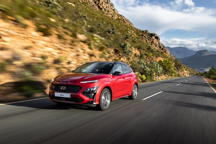 Red 2021 Hyundai Kona N Line driving on mountain road