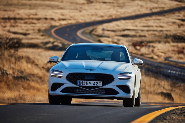 White 2021 Genesis G70 3.3T Sport on winding road