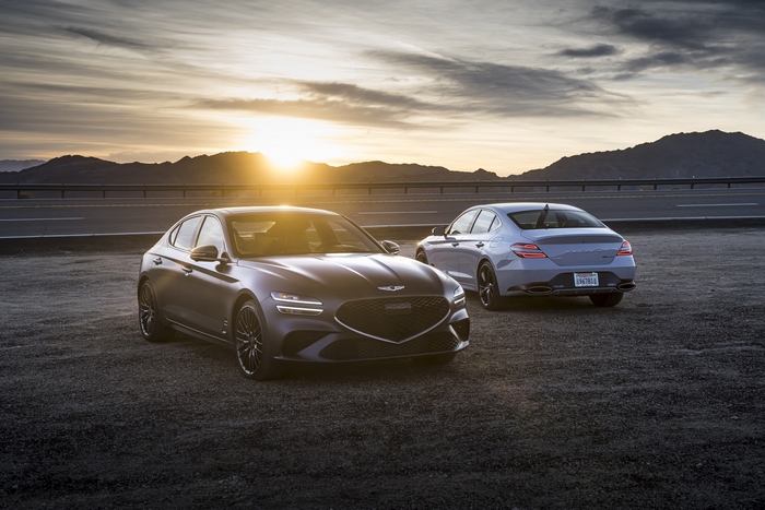 Genesis G70 sedans at sunset on a desert road