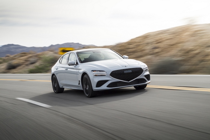 White 2022 Genesis G70 3.3T AWD driving on road