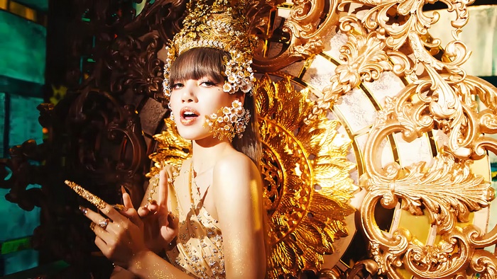 Lisa from BLACKPINK in a golden costume