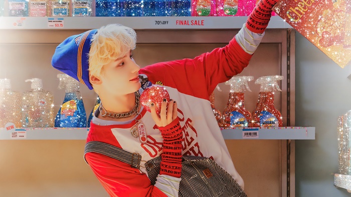 Hueningkai from Tomorrow X Together holding a red ornament