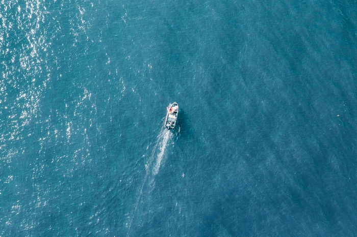 Aerial view of a boat sailing on the ocean
