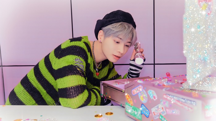 Taehyun from Tomorrow X Together holding a bottle