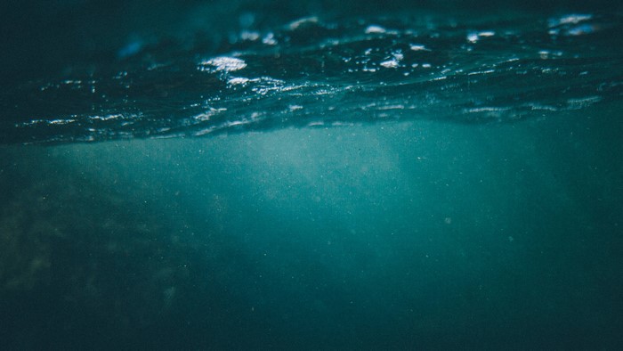 Underwater view of the ocean surface with light rays