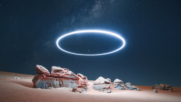 Glowing ring in desert under starry night sky