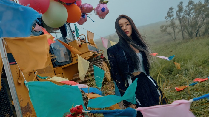 Irene from Red Velvet with balloons and flags
