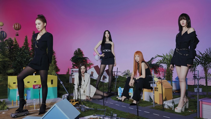 Red Velvet members in a miniature town setting