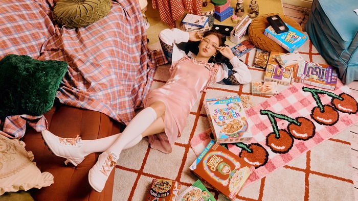 Yeri from Red Velvet lying on the floor with cereal boxes