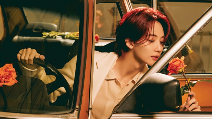 Jeonghan from Seventeen in a car with roses