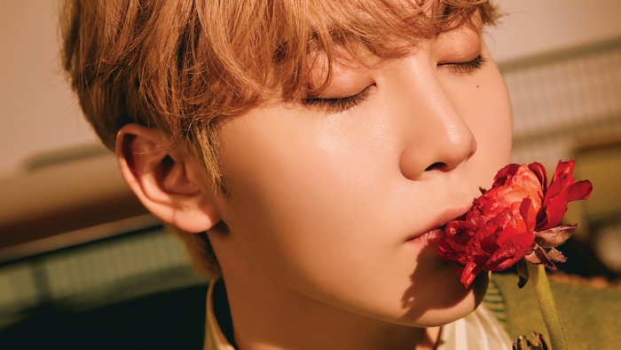 Seungkwan from Seventeen with a red flower