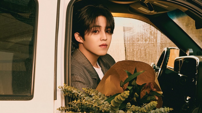 S.Coups from Seventeen in a car with flowers