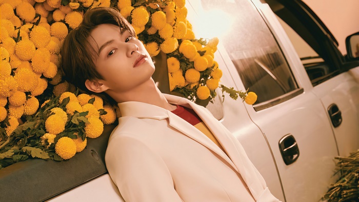 Jun from Seventeen with yellow flowers
