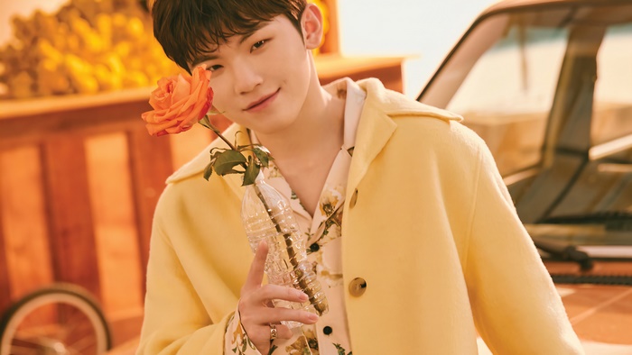 Woozi from SEVENTEEN holding a rose