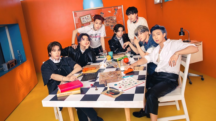 BTS group members sitting at a table