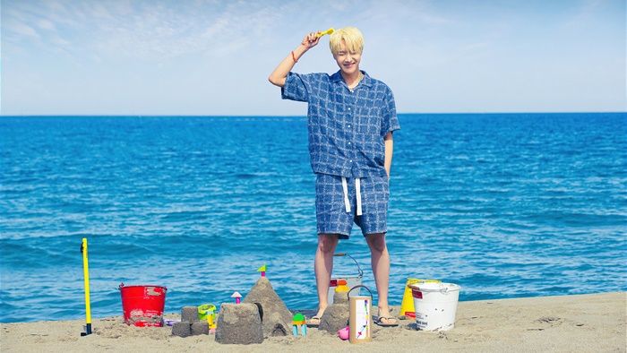 J-Hope from BTS on a beach with sandcastle toys