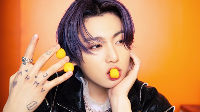 Jungkook from BTS with yellow candies