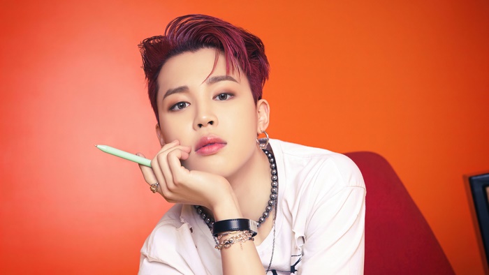 Jimin from BTS holding a pen