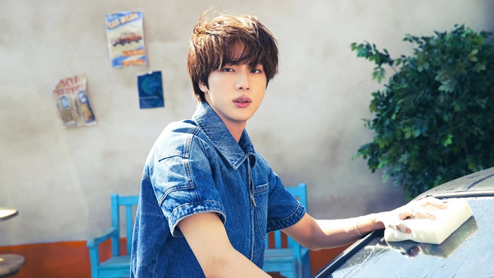 Jin from BTS washing a car