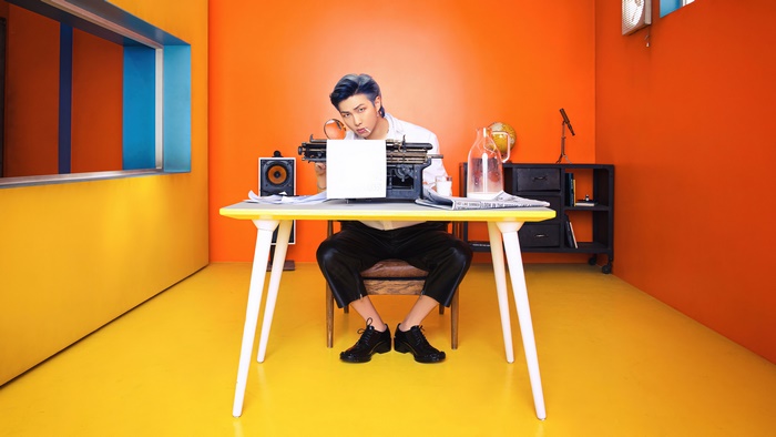 RM from BTS at a desk with a typewriter