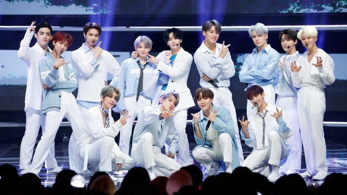 Seventeen members in white and blue outfits