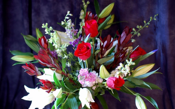 Beautiful red roses and lilies in a floral arrangement
