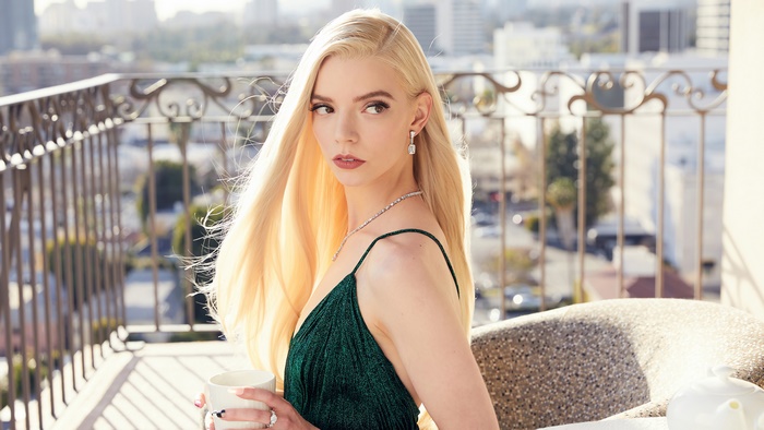 Anya Taylor-Joy on a balcony with a coffee cup