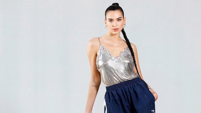 Dua Lipa in silver top and blue shorts