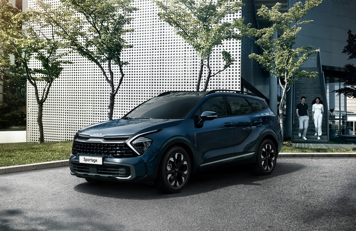 Blue Kia Sportage X-Line SUV parked outside modern building