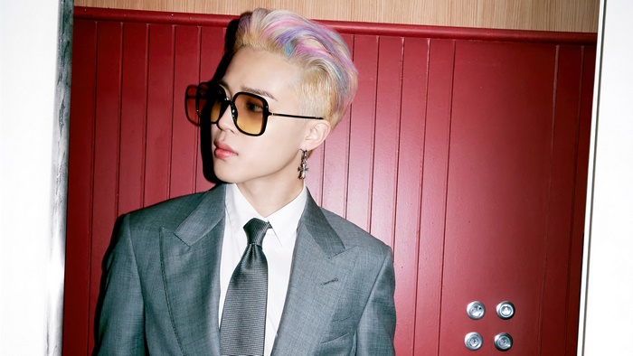 Jimin from BTS wearing a suit and sunglasses