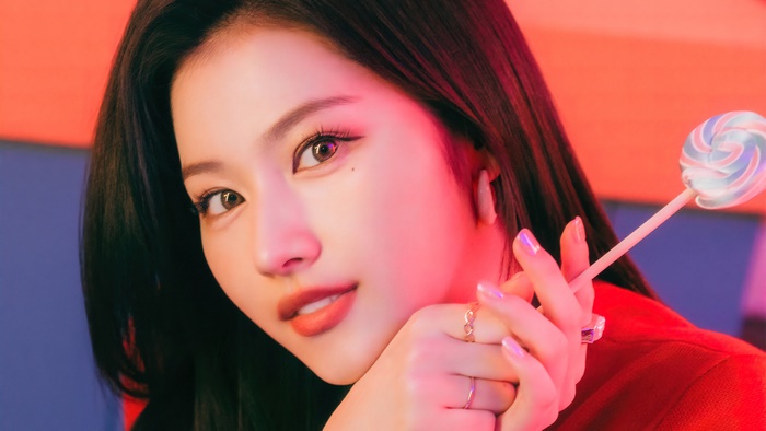 Sana from Twice with a lollipop