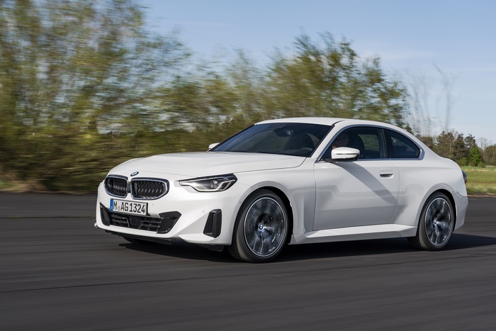 White BMW 220i Coupe driving on a road