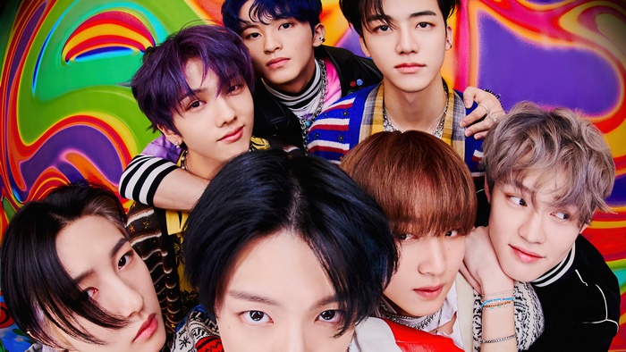 NCT Dream members in colorful psychedelic background