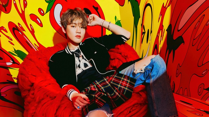 Chenle from NCT Dream in a colorful room