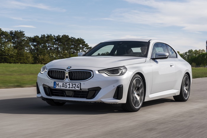 White BMW 220i Coupe driving on a road