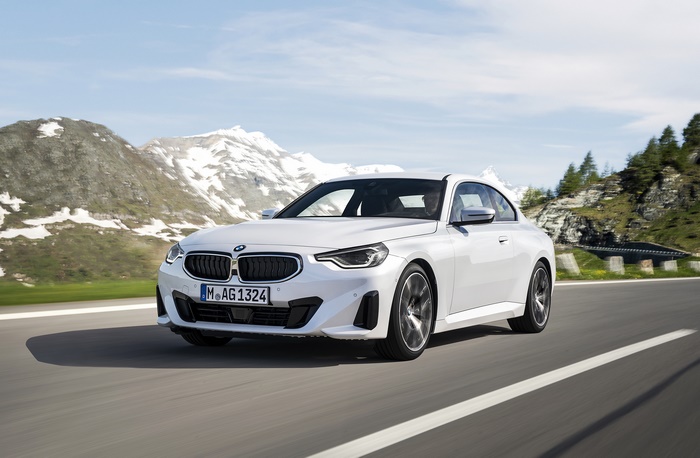 White BMW 220i Coupe driving on a mountain road
