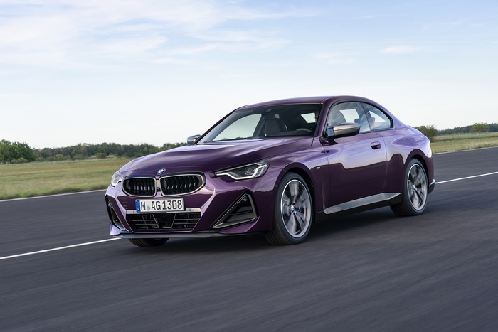 Purple BMW M240i xDrive Coupé driving on a road