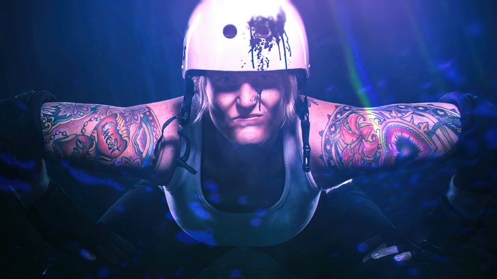 Roller derby player with tattoos and helmet