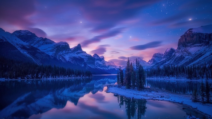 Mountain lake at sunrise with stars