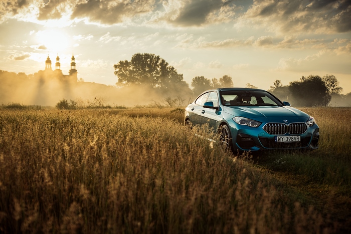 Blue BMW 220i Gran Coupé M Sport in a field at sunset