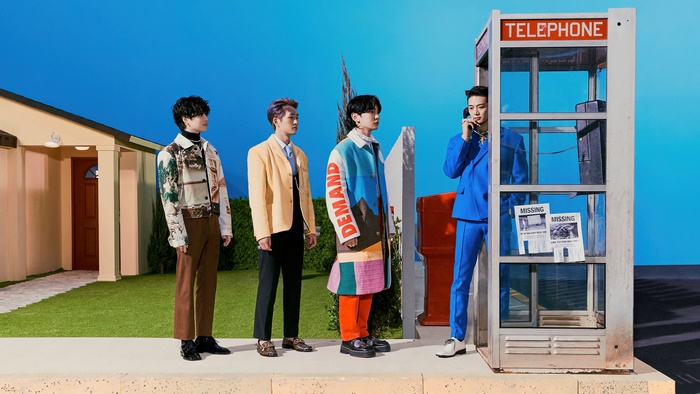 SHINee members in a surreal outdoor setting with a telephone booth