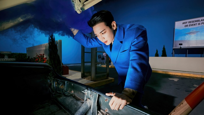 Minho from SHINee in blue suit with blue smoke